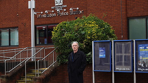 Paul Kohler MP standing in front of Wimbledon Police Station