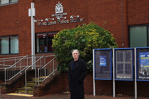 Paul Kohler MP standing in front of Wimbledon Police Station